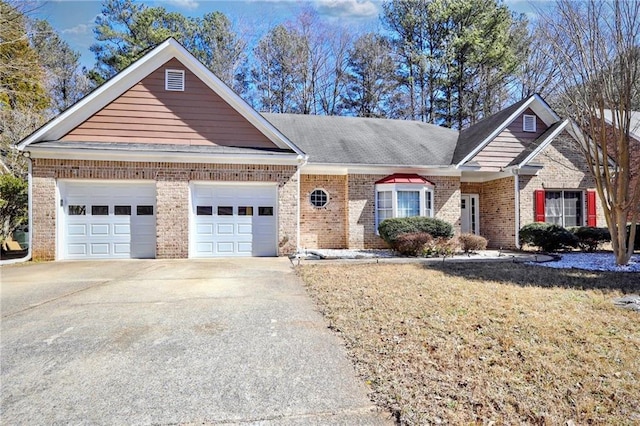 view of front of house with concrete driveway, brick siding, a front lawn, and an attached garage