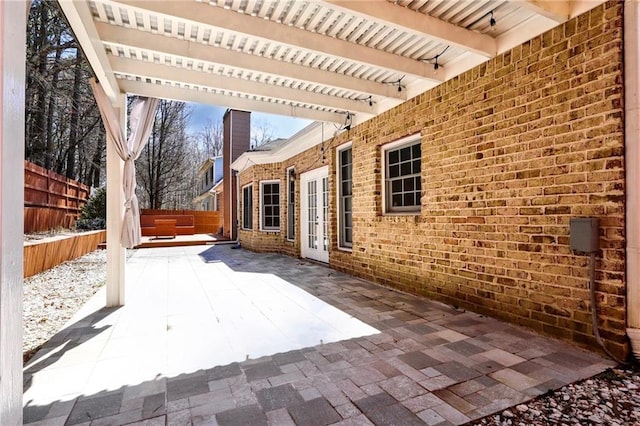 view of patio / terrace with french doors, fence, and a pergola