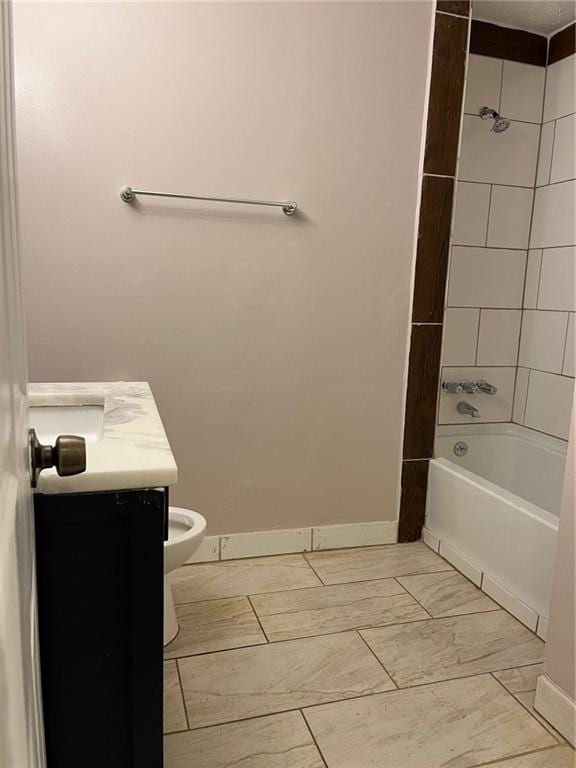 full bathroom featuring vanity, toilet, and tiled shower / bath