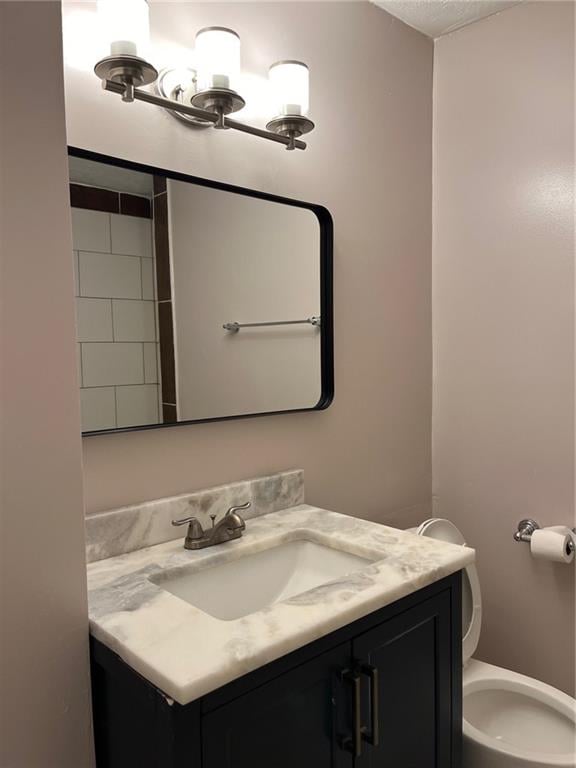 bathroom featuring vanity and toilet