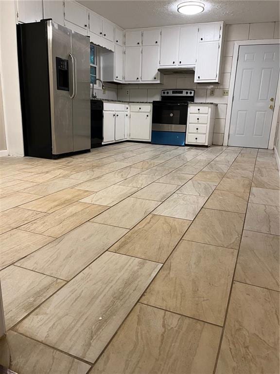 kitchen featuring a textured ceiling, stainless steel appliances, white cabinetry, and tasteful backsplash