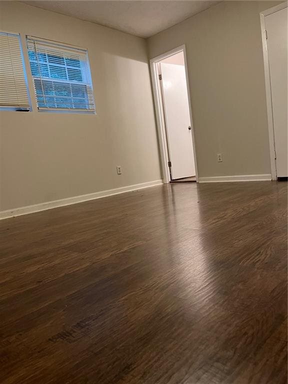 spare room featuring dark hardwood / wood-style flooring