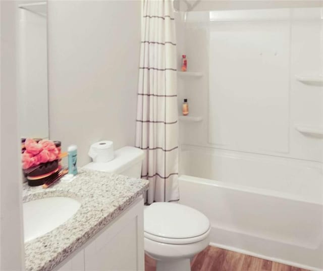 20 Sloane Ct, Covington, GA 30016 - bathroom with toilet, vanity, shower / bath combo with shower curtain, and wood finished floors