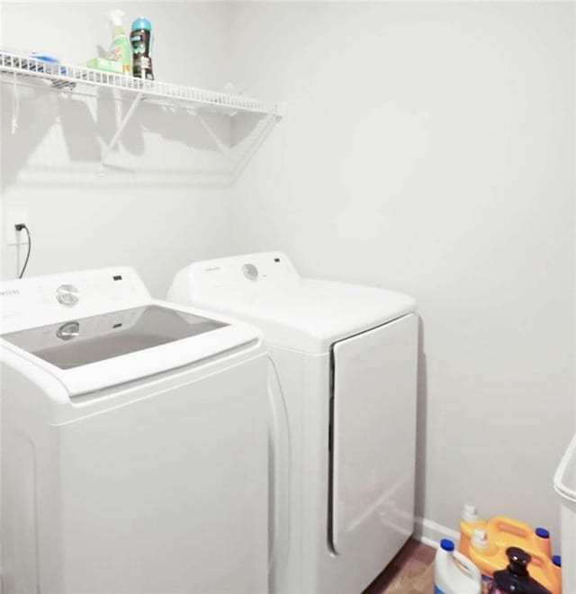 20 Sloane Ct, Covington, GA 30016 - washroom with washing machine and clothes dryer and baseboards