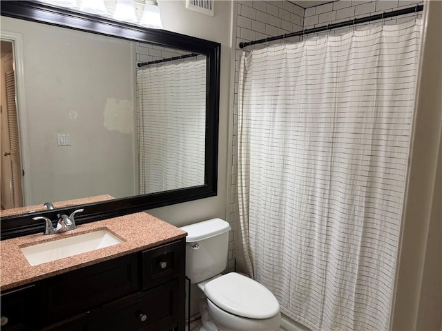 bathroom with vanity, toilet, and walk in shower