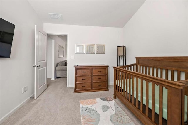 carpeted bedroom with a crib