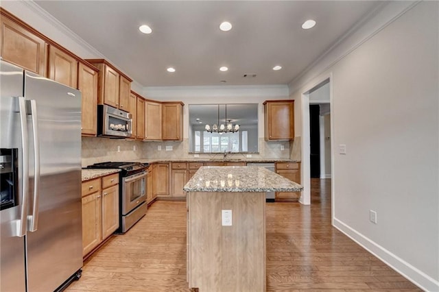 kitchen featuring a sink, ornamental molding, and appliances with stainless steel finishes