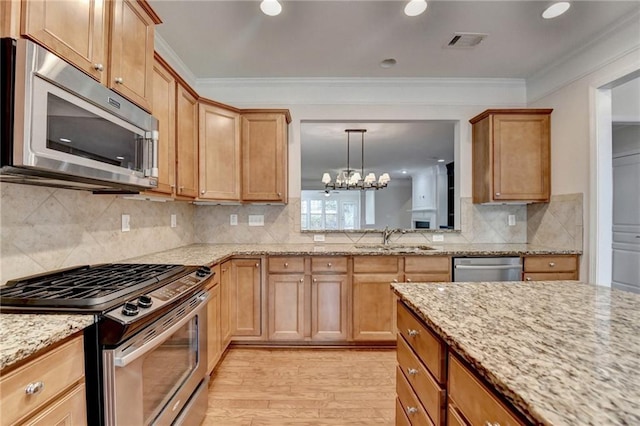 kitchen with visible vents, a sink, crown molding, and appliances with stainless steel finishes