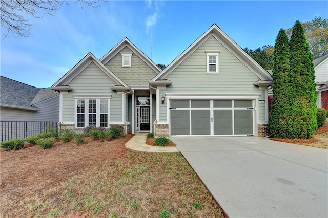 craftsman house featuring a garage, brick siding, and concrete driveway