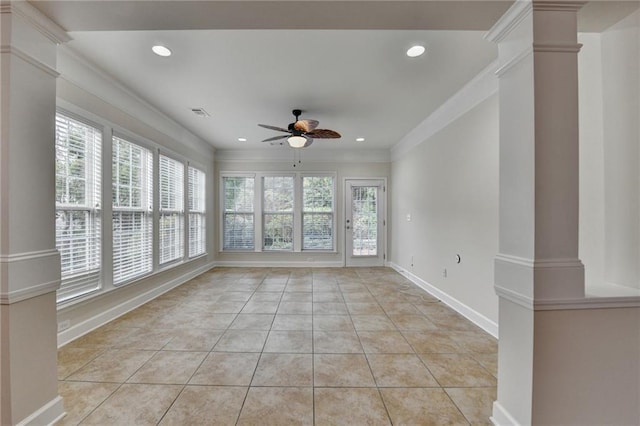 spare room with baseboards, ornate columns, ornamental molding, a ceiling fan, and light tile patterned floors