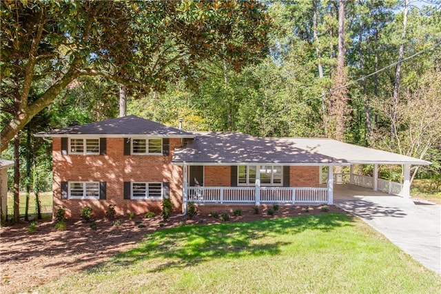 split level home featuring covered porch, a front lawn, and a carport