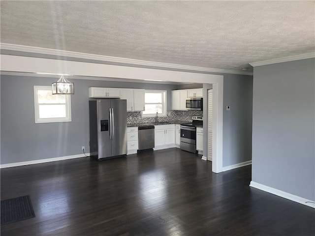 4664 Ryan Rd, Conley, GA 30288 - kitchen featuring appliances with stainless steel finishes, a sink, dark countertops, a chandelier, and white cabinets