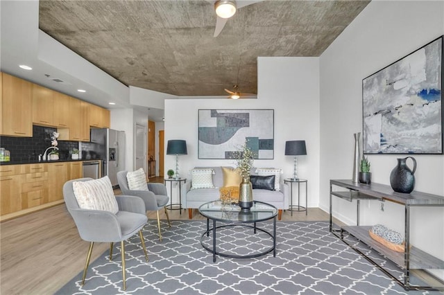 living area with light wood-style floors and baseboards