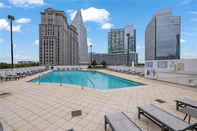 pool with a view of city and a patio