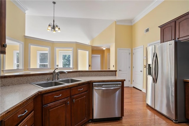 kitchen with ornamental molding, sink, appliances with stainless steel finishes, an inviting chandelier, and light wood-type flooring