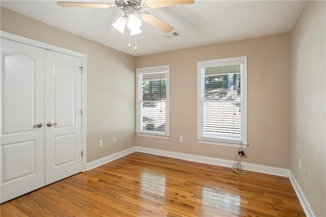 unfurnished bedroom featuring ceiling fan, a closet, and light hardwood / wood-style floors