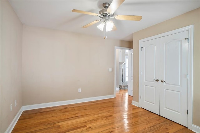 unfurnished bedroom featuring ceiling fan, a closet, and light hardwood / wood-style floors