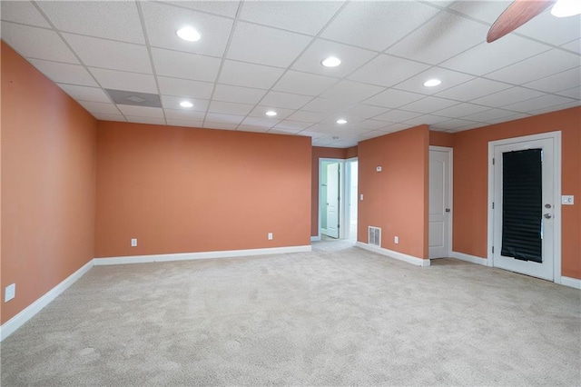 carpeted spare room featuring a paneled ceiling