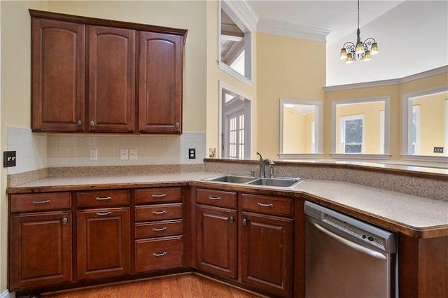 kitchen featuring a wealth of natural light, a chandelier, sink, and stainless steel dishwasher
