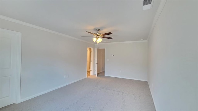 spare room with crown molding, ceiling fan, visible vents, and baseboards