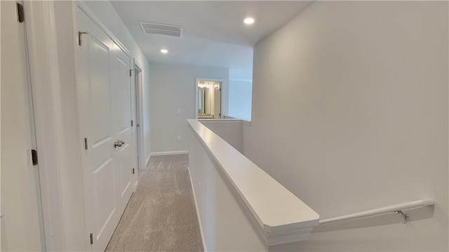 corridor featuring recessed lighting, light colored carpet, an upstairs landing, baseboards, and visible vents