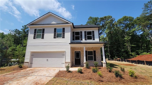 craftsman inspired home featuring a garage, brick siding, and driveway