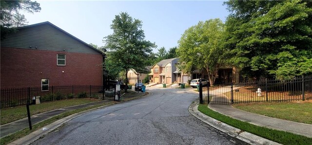 5719 Singlebriar Ct, Norcross, GA 30093 - view of asphalt road featuring sidewalks, curbs, and a gate