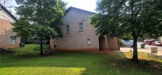 5719 Singlebriar Ct, Norcross, GA 30093 - view of home's exterior featuring brick siding and a yard