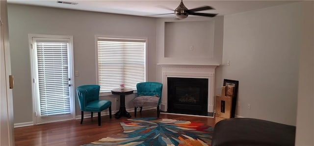 5719 Singlebriar Ct, Norcross, GA 30093 - sitting room featuring a glass covered fireplace, a ceiling fan, wood finished floors, and baseboards