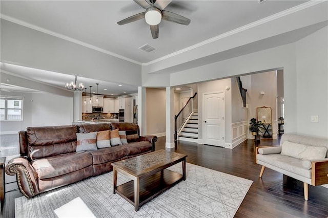 7470 Oldbury Pl, Cumming, GA 30040 - living area with stairway, wood finished floors, a ceiling fan, crown molding, and baseboards
