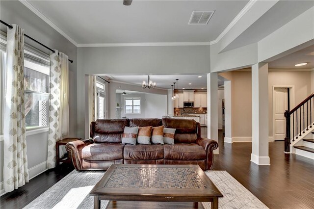 7470 Oldbury Pl, Cumming, GA 30040 - living room with ornamental molding, dark wood-style floors, stairway, baseboards, and a chandelier