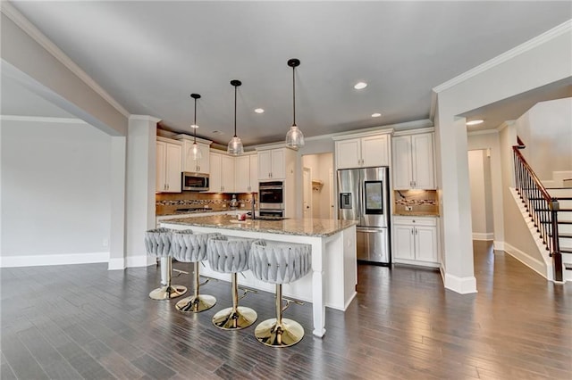 7470 Oldbury Pl, Cumming, GA 30040 - kitchen featuring stainless steel appliances, backsplash, baseboards, light stone counters, and a breakfast bar