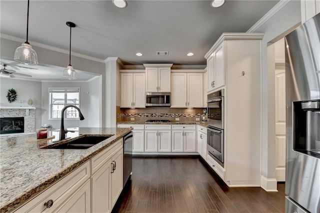 7470 Oldbury Pl, Cumming, GA 30040 - kitchen featuring a sink, appliances with stainless steel finishes, light stone countertops, dark wood-style flooring, and white cabinetry