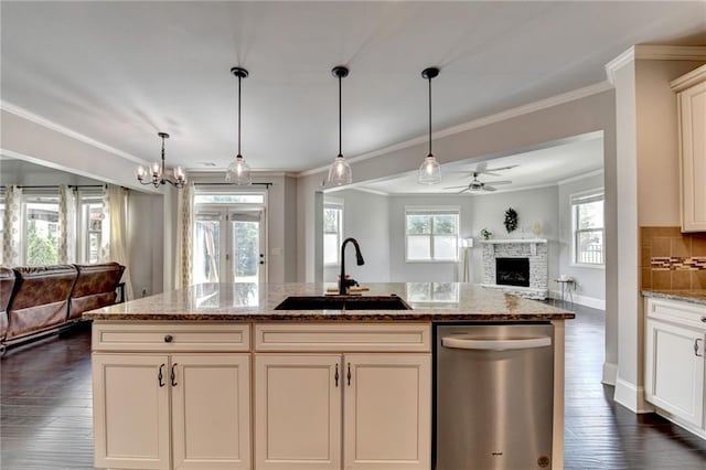 7470 Oldbury Pl, Cumming, GA 30040 - kitchen featuring dishwasher, a sink, open floor plan, ornamental molding, and a fireplace