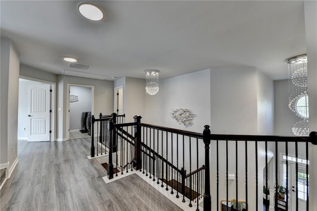 7470 Oldbury Pl, Cumming, GA 30040 - hall with an upstairs landing, wood finished floors, and baseboards