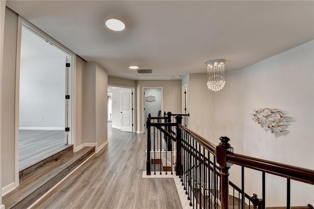 7470 Oldbury Pl, Cumming, GA 30040 - corridor with an upstairs landing, wood finished floors, and baseboards