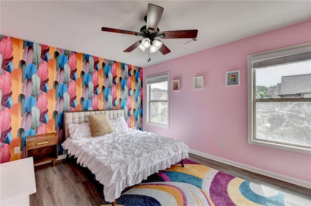 7470 Oldbury Pl, Cumming, GA 30040 - bedroom with multiple windows, wood finished floors, and baseboards