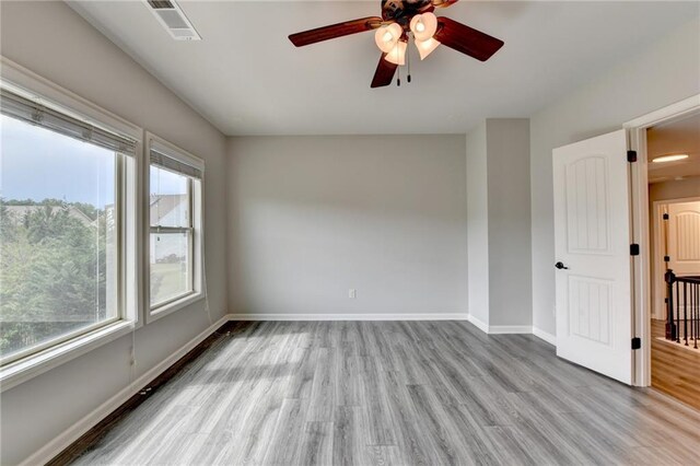 7470 Oldbury Pl, Cumming, GA 30040 - unfurnished room featuring baseboards, wood finished floors, and a ceiling fan