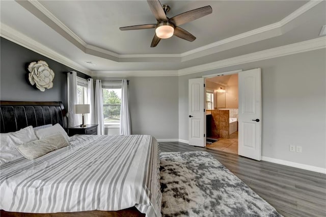 7470 Oldbury Pl, Cumming, GA 30040 - bedroom with a tray ceiling, baseboards, wood finished floors, ornamental molding, and connected bathroom