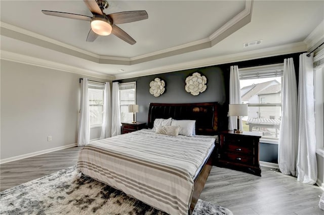7470 Oldbury Pl, Cumming, GA 30040 - bedroom with a tray ceiling, multiple windows, wood finished floors, baseboards, and crown molding