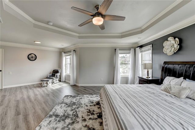 7470 Oldbury Pl, Cumming, GA 30040 - bedroom featuring a raised ceiling, multiple windows, wood finished floors, crown molding, and a ceiling fan
