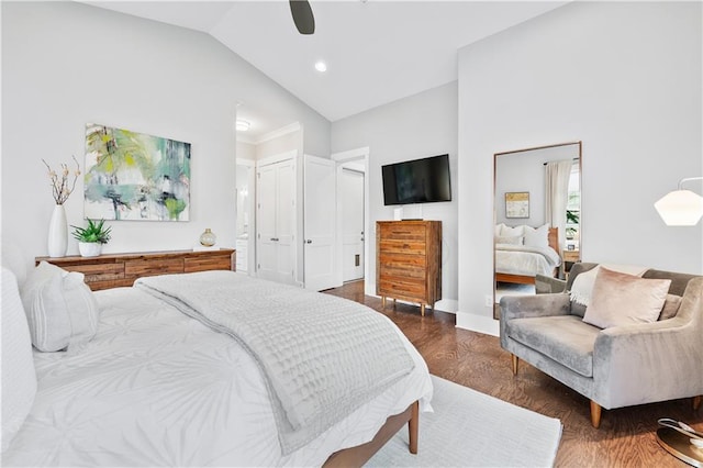 bedroom with ceiling fan, dark hardwood / wood-style floors, a closet, and lofted ceiling