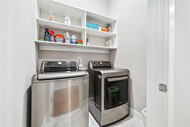 clothes washing area featuring washer and clothes dryer