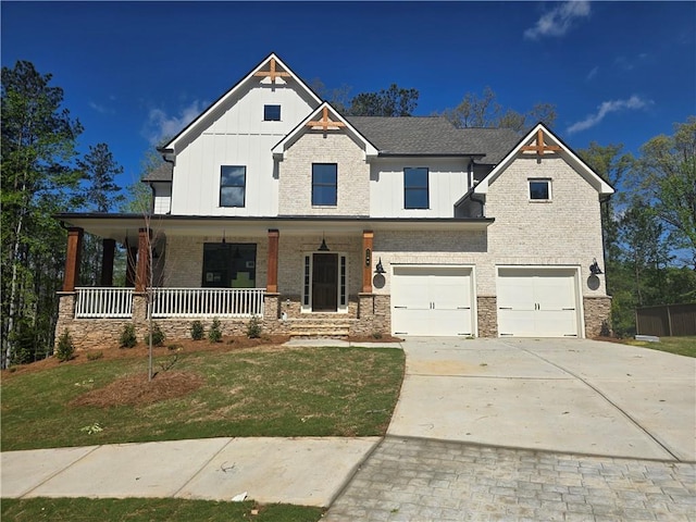 3677 Thornhill Ct, Douglasville, GA 30135 - view of front of home with board and batten siding, a garage, driveway, covered porch, and a front yard