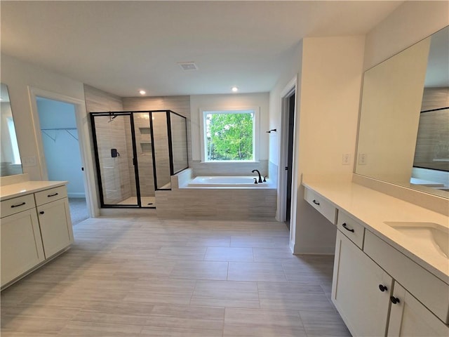 3677 Thornhill Ct, Douglasville, GA 30135 - bathroom featuring a shower stall, a bath, vanity, recessed lighting, and a walk in closet