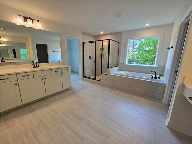 3677 Thornhill Ct, Douglasville, GA 30135 - full bath with a bath, a shower stall, vanity, a walk in closet, and recessed lighting