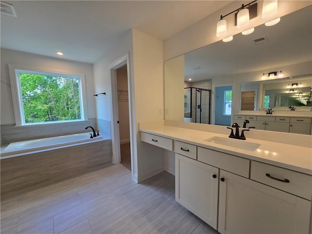 3677 Thornhill Ct, Douglasville, GA 30135 - bathroom with a shower stall, a bath, a spacious closet, vanity, and baseboards