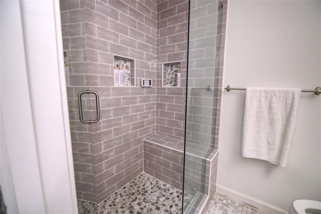 bathroom featuring toilet and walk in shower