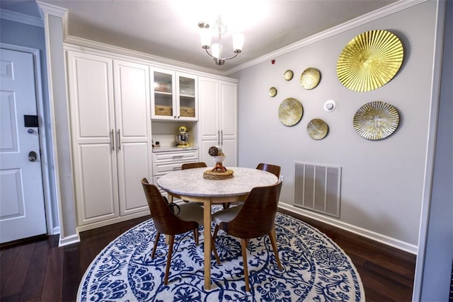 dining room with dark wood-type flooring and ornamental molding