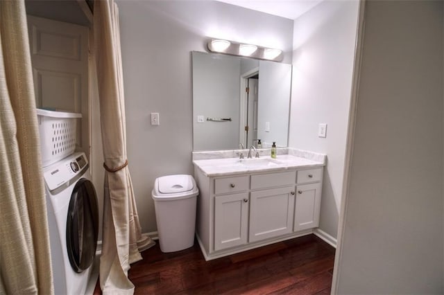 bathroom featuring vanity, washer / clothes dryer, wood-type flooring, and toilet